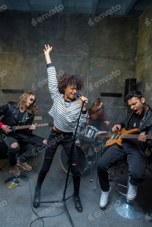Preview: Young multiethnic rock and roll band rehearsing in musical studio