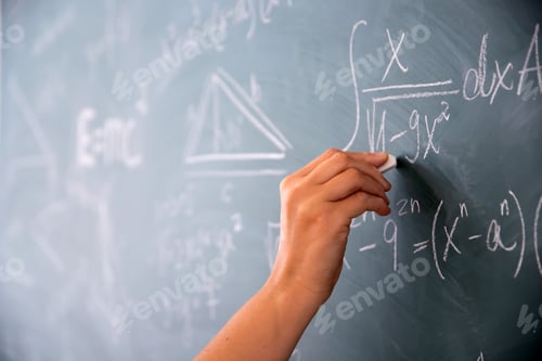 Preview: Teacher or student writing on blackboard during math lesson in school classroom
