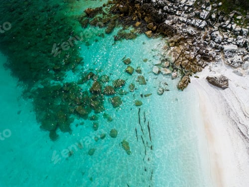 Preview: The beach with white marble pebbles and turquoise sea on the Greek island of Thassos. Aerial view