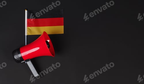Preview: German flag and red megaphone on black background