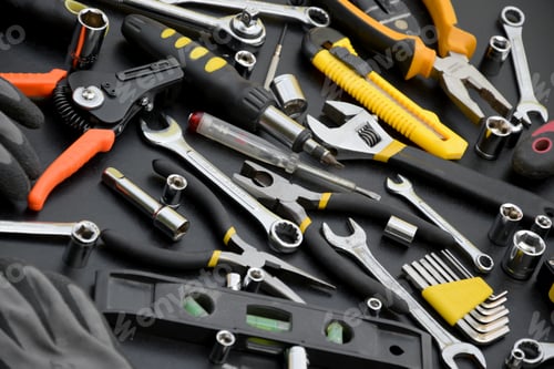 Preview: Handyman tool kit on black wooden table. Many wrenches and screwdrivers
