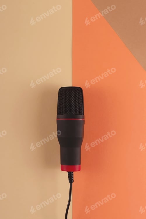 Preview: Podcasting concept - microphone at blogger's workplace on a combined beige background.