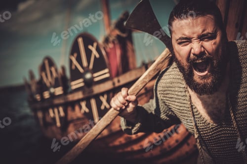 Preview: Viking with axe standing near drakkar on the seashore.