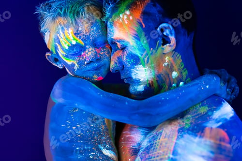 Preview: Young father and son. Painted with fluorescent paint using UV light