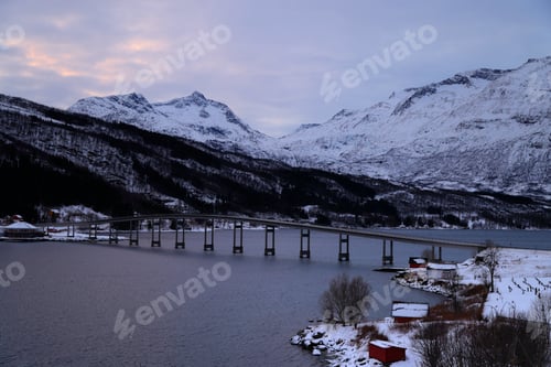 Preview: a snowy river with a bridge in the middle surrounded by mountains