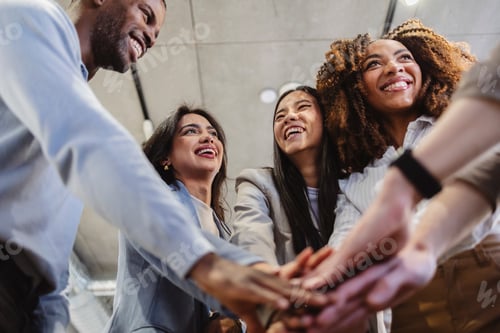 Preview: Business team joining hands, celebrating success and teamwork in office