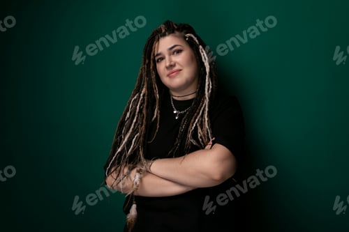 Preview: Woman With Dreadlocks Standing in Front of Green Wall