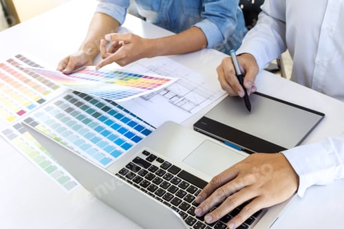 Preview: Team of colleague graphic designer drawing and retouching image on graphics tablet and choose color