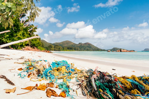 Preview: Close-up of colorful fishing net and rope on tropical sandy beach.