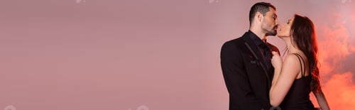 Preview: sexy woman in black dress pulling tie while seducing man in formal wear on pink and grey, banner