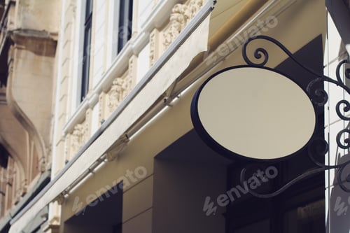 Preview: round empty signboard on a building with classical architecture