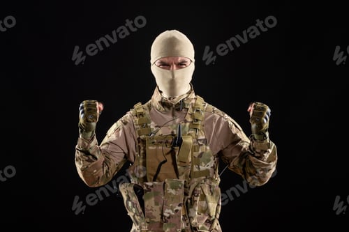 Preview: front view of young soldier in uniform and mask on black background tank israel