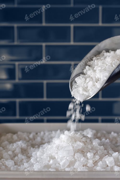 Preview: Water softener salt pouring from a scoop into container