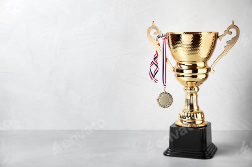 Preview: Shiny golden trophy cup and medal on white background