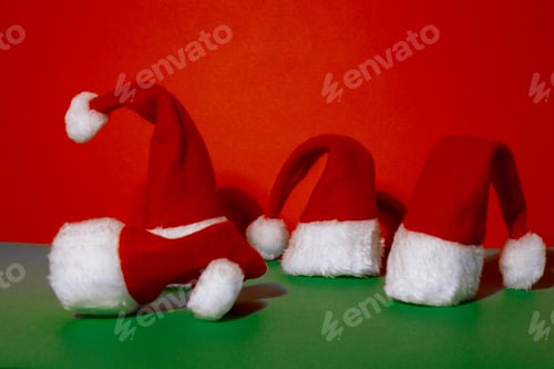 Preview: Santa hats on isometric green red background. Copy space for your text. Mock up for advertisement