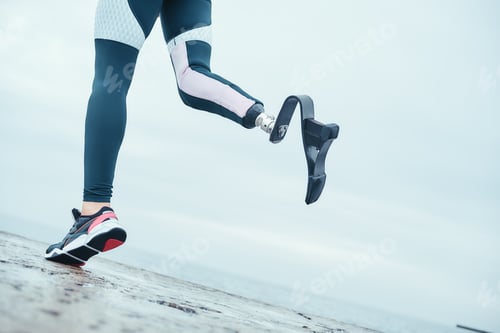 Preview: Life is in your hands. Cropped photo of disabled woman with bionic leg in sportswear is running on