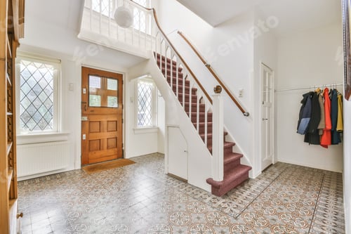 Preview: Large entrance hall with a wooden door and stairs