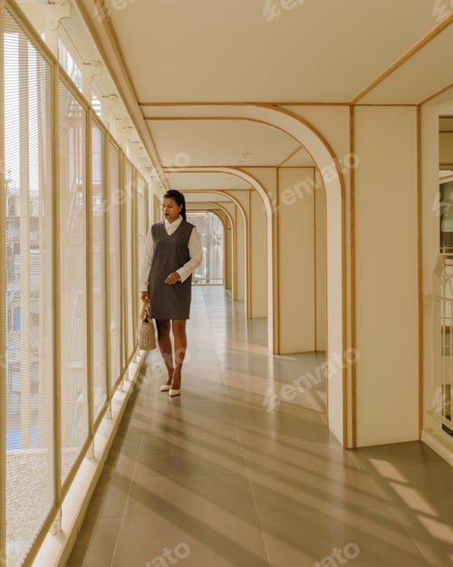 Preview: Asian women at the balcony of an art deco luxury hotel architecture from the 80s