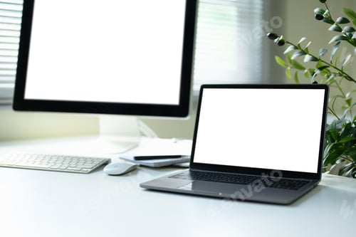 Preview: Modern white desk with a large desktop monitor and a laptop