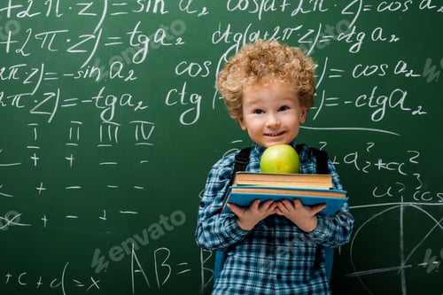 Preview: cheerful kid holding books and apple near chalkboard with mathematical formulas