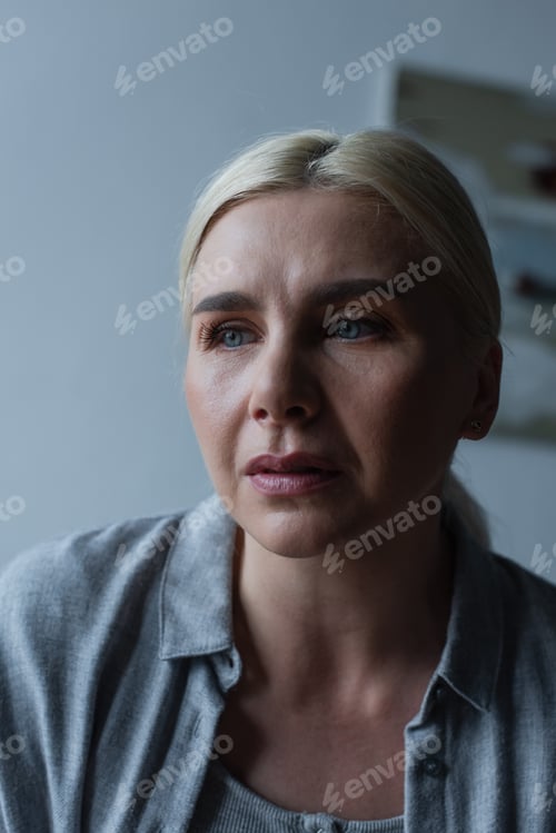 Preview: portrait of upset blonde woman with menopause looking away