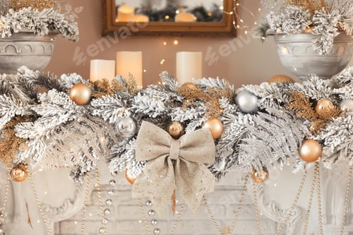 Preview: Composition of a christmas garland with candles, silver balls and a golden bow on the fireplace