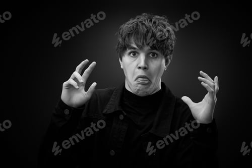 Preview: portrait of crazy young man showing the tongue.