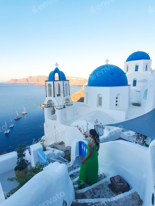 Preview: A serene sunset stroll along the steps in Santorini with stunning blue domes in view