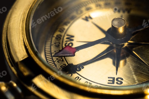 Preview: Golden brass compass closeup with south direction