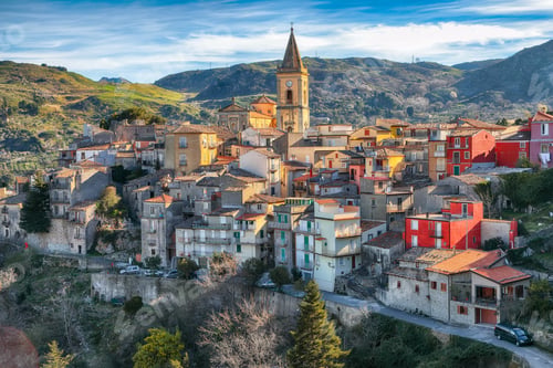 Preview: Amazing Panorama of the belltower and the village in the valley at early sunrise.