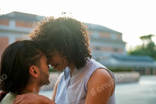 Preview: Interracial couple embracing, sharing romantic outdoor moment