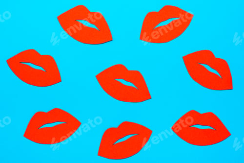Preview: World Kiss Day. Many red lips made of cardboard on a blue background