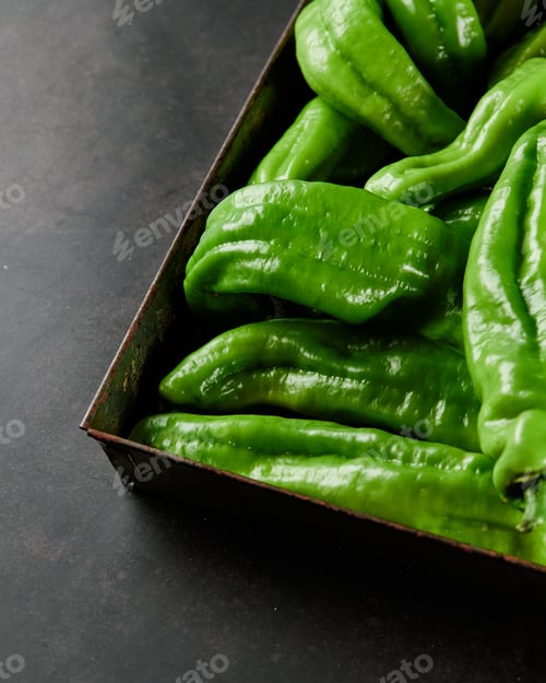 Preview: Vertical closeup shot of a box full of green chili peppers also known as Anaheim Pepper