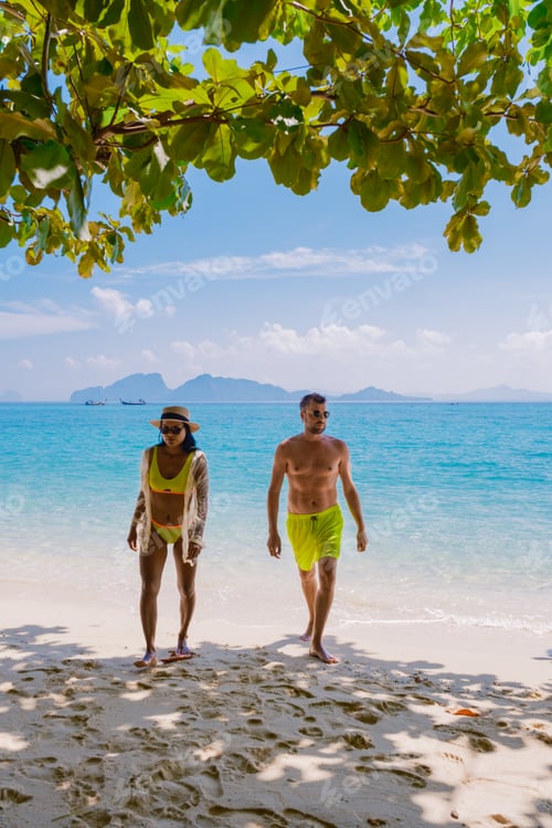 Preview: a couple of men and woman on the beach of Koh Kradan Island Thailand