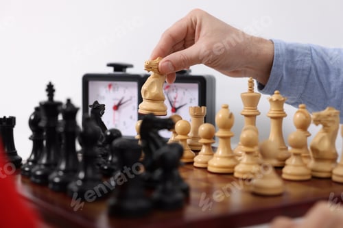 Preview: Man playing chess at table indoors, closeup