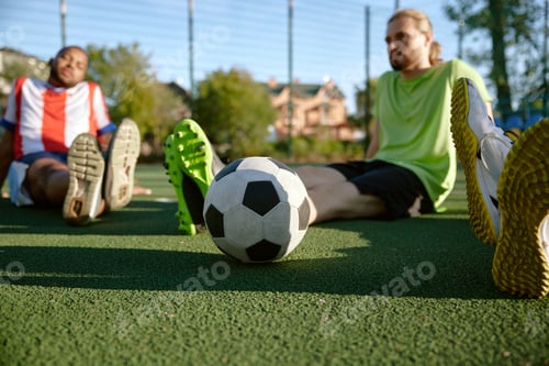 Preview: Smiling football player resting on field talking sharing expression
