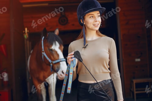 Preview: Beautiful woman standing with a horse