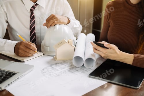 Preview: Image of engineer meeting for architectural project. working with partner and engineering tools