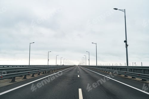 Preview: Empty highway with asphalt road and cloudy sky