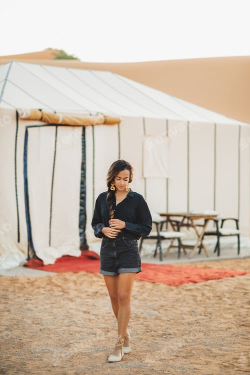 Preview: Fashion stylish portrait of young oriental brunette woman in black clothes. Standing near glamping