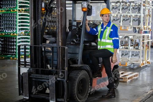 Preview: Man wear safety helmet stand beside forklift warehouse in factory. Male worker industrial operate