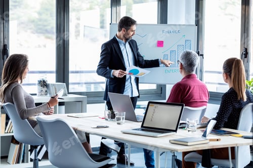 Preview: Handsome businessman explaining a project to his colleagues on coworking place.