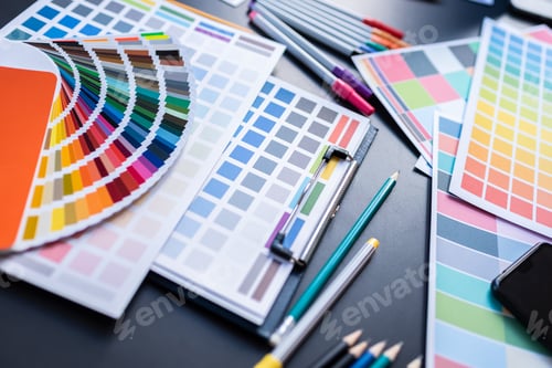 Preview: Color swatches of graphic designers putting on desk table.