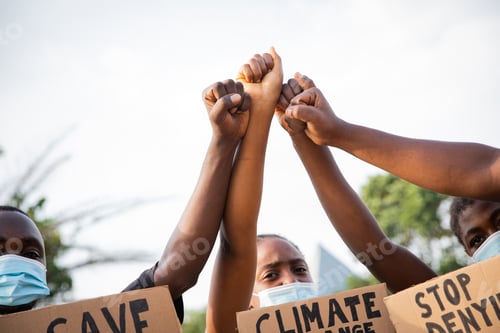Preview: Close-up of the raised fists of a group of African guys protesting.