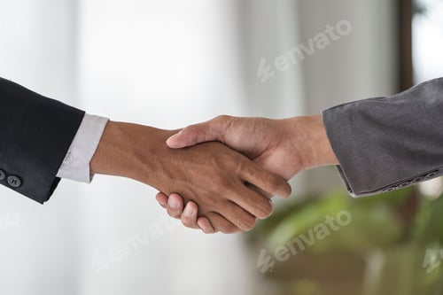 Preview: Successful Businessmen Shaking Hands and Signing a Contract Together in a Modern Office Setting