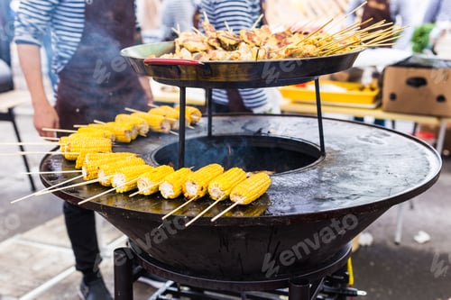Preview: Preparing hot grilled corn outdoors at summer. Street food