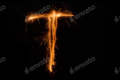 Preview: The English Letter T Made Of Sparklers On Black Background