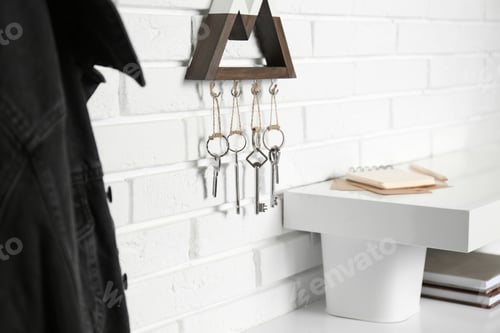 Preview: Wooden key holder on white brick wall indoors
