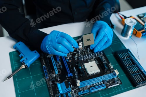 Preview: Hands repairing electronic devices. Electronic technician.