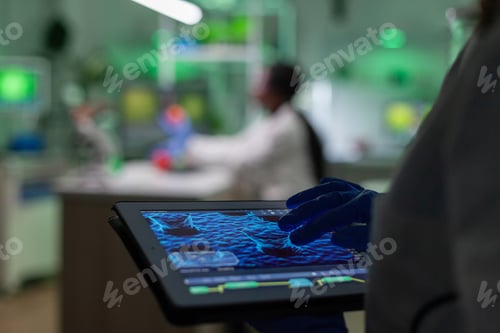 Preview: Scientist researcher doctor analyzing genetic mutation test using tablet